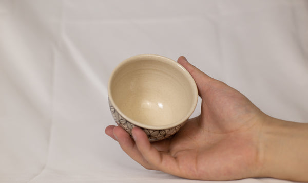 Cup features a detailed geometric pattern that showcases intricate artistry