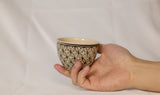 Cup features a detailed geometric pattern that showcases intricate artistry