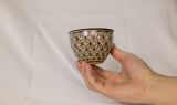 Cup features a detailed geometric pattern that showcases intricate artistry