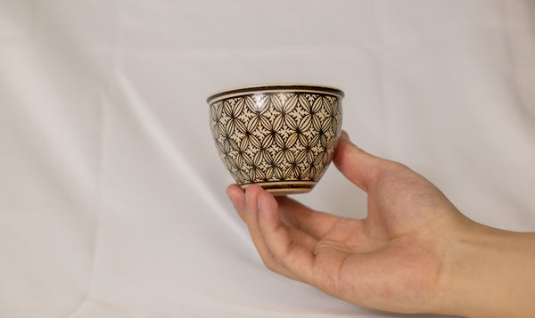 Cup features a detailed geometric pattern that showcases intricate artistry